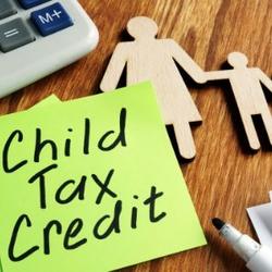 Child Tax Credit written on sticky note next to mother and child cut outs