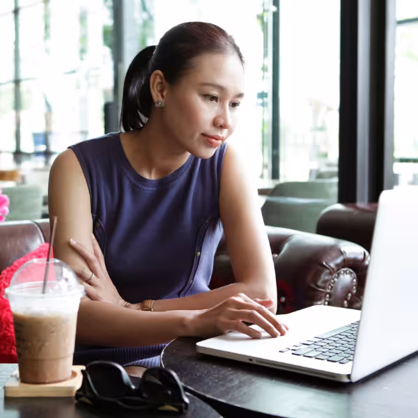 Woman checking her email in a coffee shop