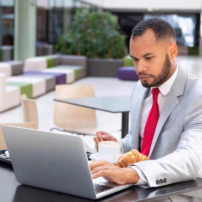 Professional Man Working on his Computer at a Cafe