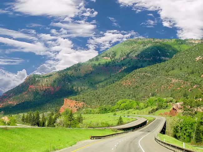 Paved road leading to a mountain