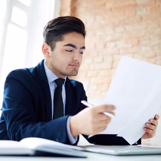 Man sitting at his desk looking at papers