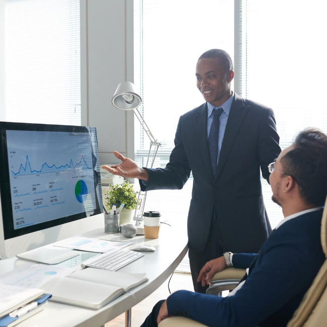 Businessmen discussing metrics on the computer screen