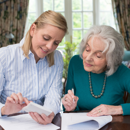Tax Professional helping an older adult with filing a tax return